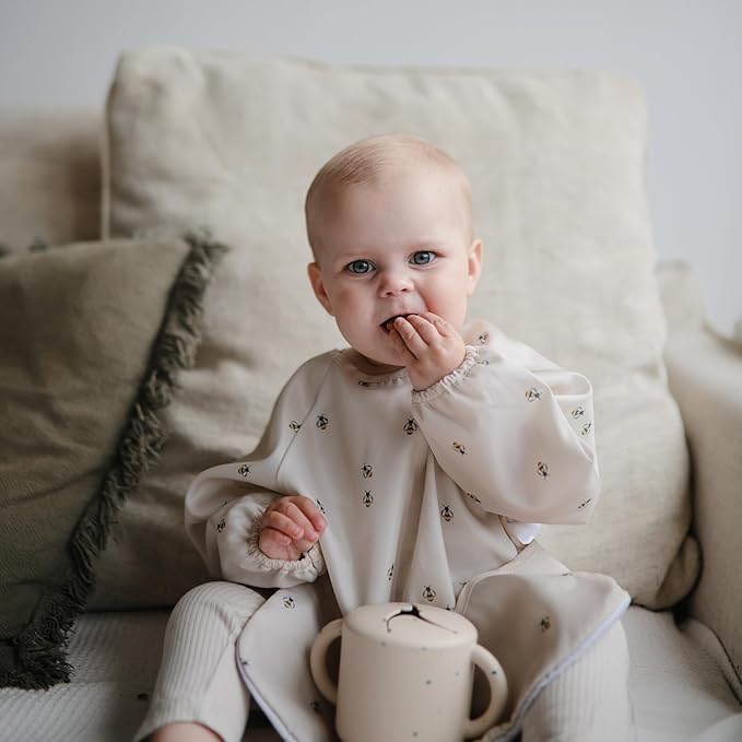 mushie Long Sleeve Baby Bib | Water Resistant Adjustable Fit for Ages 6-24 Months